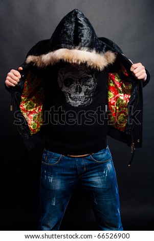 guy on a black background in a jacket with a hood with his head down