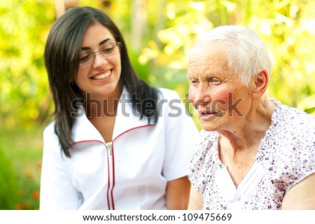 Elderly woman chatting with the doctor / nurse.