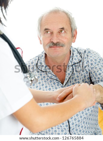 Doctor/Nurse holding elder male patient\'s hand with caring attitude.