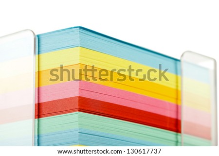 Closeup view of a block of colorful sticky notes.