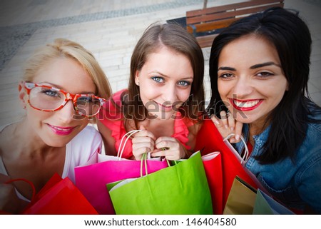 Beautiful friends spending their spare time on shopping together.