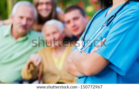 Confident Doctor Welcoming Patients, Happy Family Members - Family Medical Care Concept.