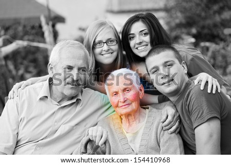 Alzheimer \'s concept - when the world closes in. An elderly woman surrounded by her family.