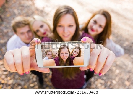 Selfie for social network with photobomb with a group of young people.