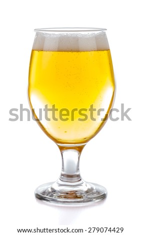 A glass of fresh draught blond beer.