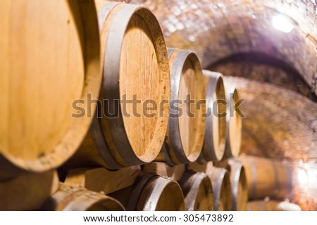 Barrels made of oak wood stacked up in cellar.
