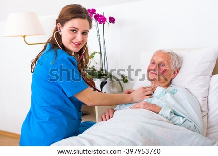 Happy elderly woman assisted by geriatric doctor, examination in the nursing home.