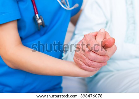 Nurse helping up senior woman, supporting her because her weakness.