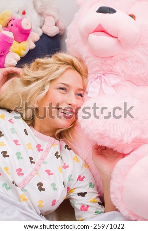 A young girl lying in bed.