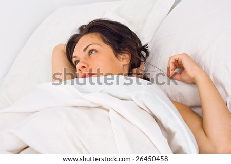 A young woman waking up at morning, thinking in the bed.