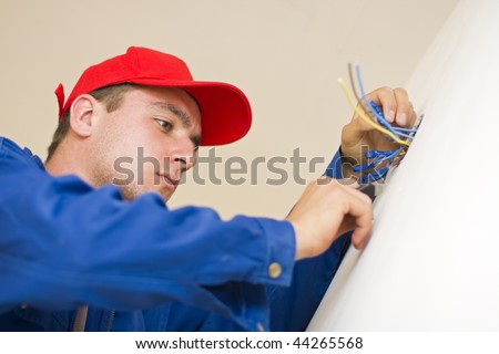 An electrician installing electricity in a new house.