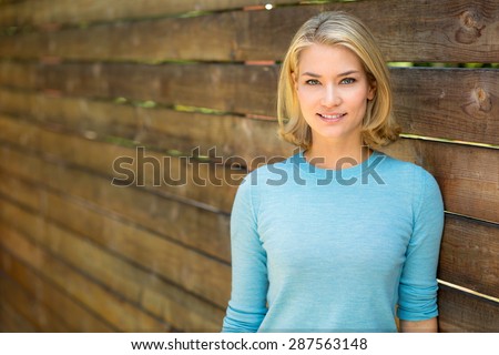 Pretty blonde single woman portrait outdoors nice teeth and hair