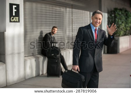 Confident elder successful man traveling at the train station