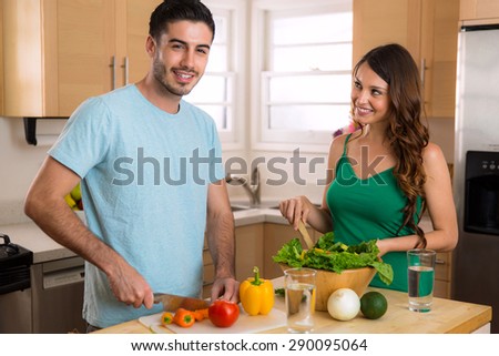 Male and female chef learn and teach each other how to cook a healthy meal