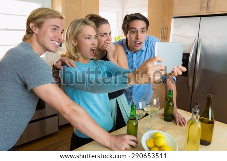 Family gathered to watch a sports game on TV tablet streaming video excited and celebrating