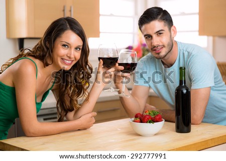 Dating with a bottle of red wine cheers and make a toast with glasses and happy smiles