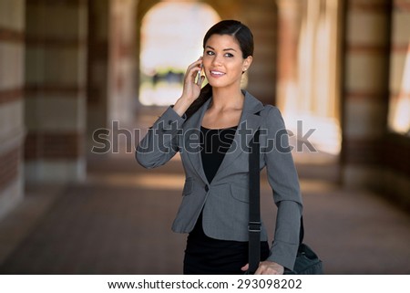 Business woman executive walking and talking on the cell phone