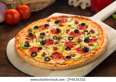 Close up of perfect pizza pie supreme deluxe toppings golden brown delicious
