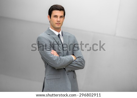 Strong handsome confident business man portrait posing with successful posture and pose in a fashionable suit