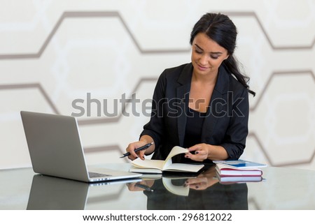 Corporate female busy writing working at the workplace office reflection table modern background