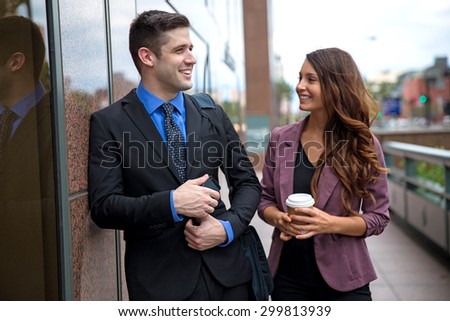Lifestyle coworkers communicating together on a work break socializing attractive single professionals love laughter