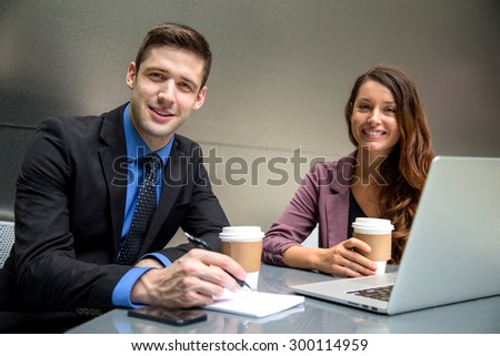 Handsome business man executive and pretty woman team colleagues at office workspace