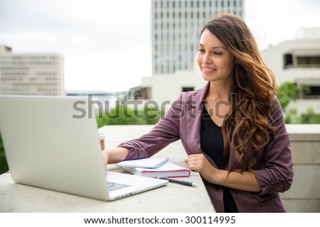 Pretty business executive working from laptop computer lifestyle buildings office