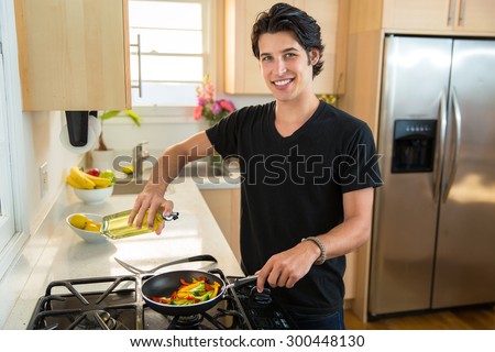 Good looking handsome male vegan vegetarian prepares a low calorie dinner