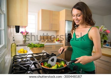 Good looking beautiful woman female vegan vegetarian prepares a low calorie dinner