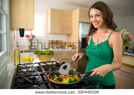 Woman home chef single portrait cooking vegetables vegan meal on stove grill