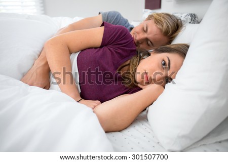 Unsatisfied couple problems troubles in bedroom lying in bed insomniac husband wife