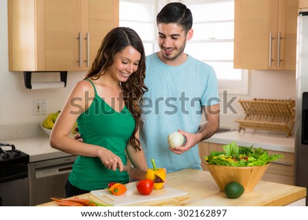 Man and woman cooking vegetable dinner on a date healthy lifestyle vegetarian meal