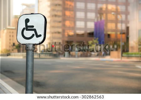 Handicap parking sign bokeh blurred blurry background urban city business district buildings downtown