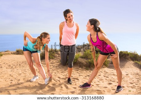 Friends women cute pretty casual conversation athletes stretching in exercise class outdoors before jog and hike on trail path