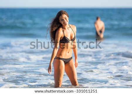 Swimsuit ocean body thin fit waist abs athletic toned playful fun water play beach fun travel vacation couple single