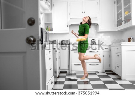 Dancing and singing while cleaning sweeping kitchen floor fun spirited joyful attitude chores