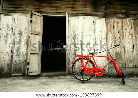 Old Style Red Bicycle And Wooden Door