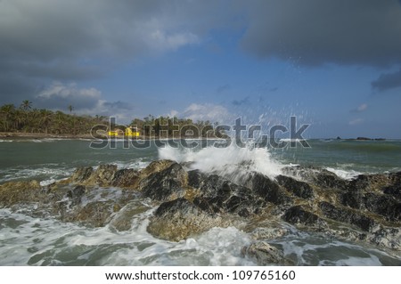 Yellow house and waves coming to Miramar beach. Colon province, Panama, Caribbean, Central America.