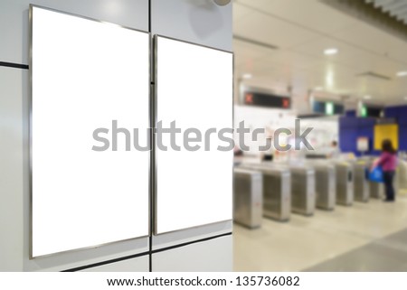 Two big vertical / portrait orientation blank billboard on wall in train station entrance