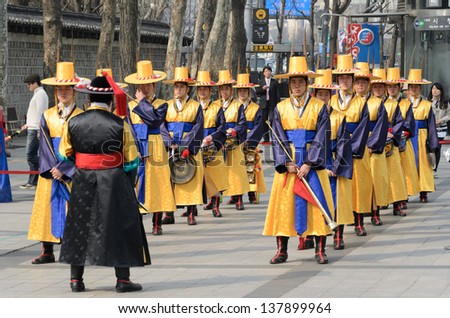 SEOUL, KOREA - March 01: Armed soldiers in period costume guard the entry gate at Deoksugung Palace, a tourist landmark, in Seoul, South Korea on March 01, 2013