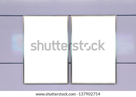 Two big vertical / portrait orientation blank billboard on purple wall