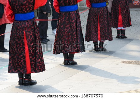 SEOUL, KOREA - MARCH 01: Armed soldiers in period costume guard the entry gate at Deoksugung Palace, a tourist landmark, in Seoul, South Korea on March 01, 2013