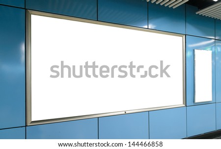One big horizontal / landscape orientation, one small vertical / portrait orientation blank billboard on blue wall