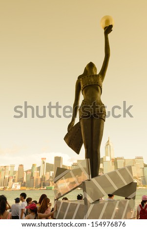 HONG KONG, CHINA - APR 17: Statue and skyline in Avenue of Stars on April 17, 2013 in Hong Kong, China. The promenade honors celebrities of the Hong Kong film industry as the famous city attraction.