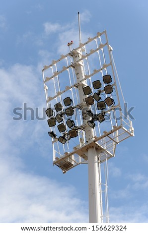 Stadium lighting pole on blue sky with cloud