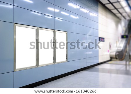 Three big vertical / portrait orientation blank billboard with escalator background in public transport