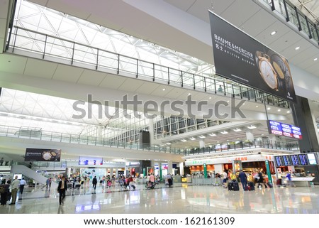 HONG KONG, CHINA - FEBRUARY 11: Passengers in the airport main lobby on February 11, 2013 in Hong Kong, China. The Hong Kong airport handles more than 70 million passengers per year.