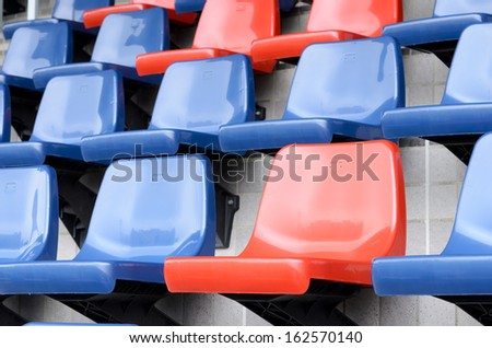 Plastic red and blue new chairs in stadium