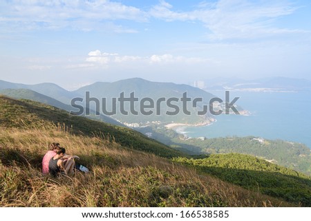 HONG KONG - OCTOBER 8 : Trekker are sitting on the mountain along the way of Dragon Back trail in Hong Kong on October 8, 2013. Dragon back trail in one of the most famous trekking trail in Hong Kong