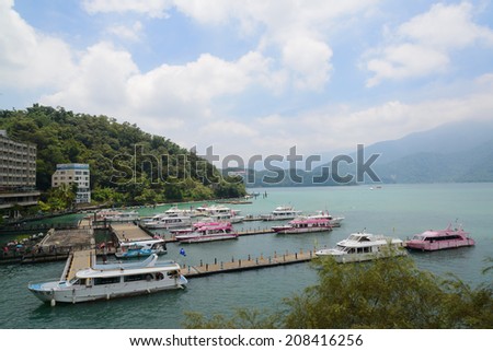 SUN MOON LAKE - JULY 15: boats park at pier on July 15, 2014 at Sun Moon Lake, Taiwan. Sun Moon Lake is the largest body of water in Taiwan as well as a tourist attraction.